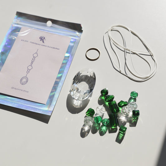 Kit DIY Suncatcher avec cristaux verts à assembler soi-même, incluant cristal principal, cristaux supplémentaires, cordon et livret explicatif. Créez une décoration unique et apaisante.