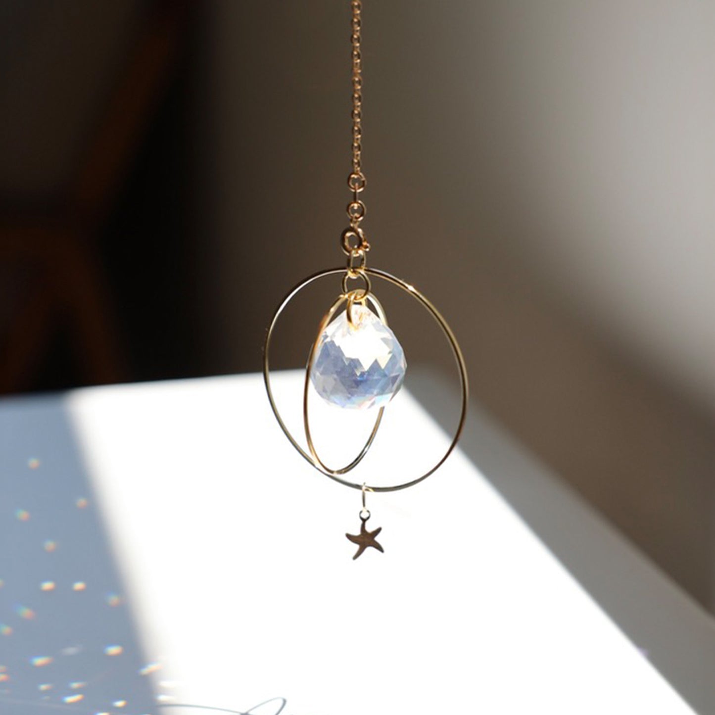 Décor lumineux avec le Suncatcher Sunset de Rayonne accroché dans une pièce baignée de lumière naturelle.