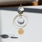 Suncatcher MAMAN en verre, suspendu près d'une fenêtre, prêt à capter les rayons du soleil.